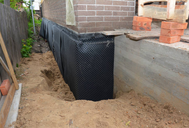 Happy homeowners after waterproofing job in Rex